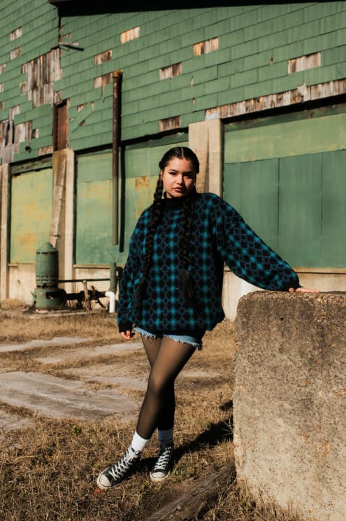 A Portrait Of A Woman Standing Outdoors