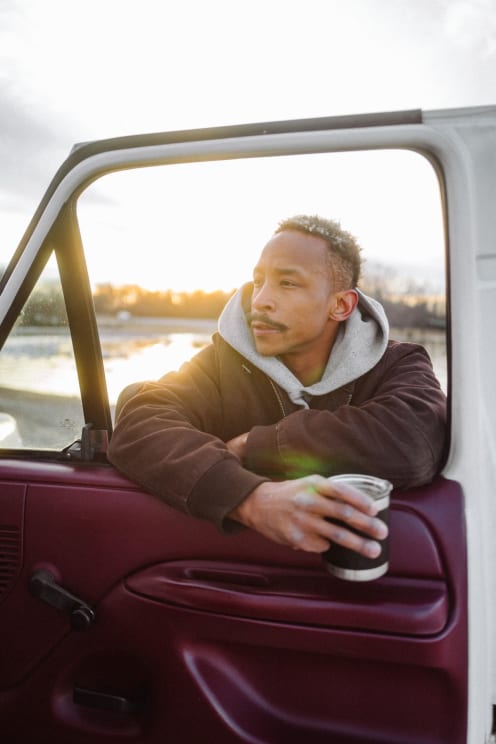 A Person On The Door Of A Truck