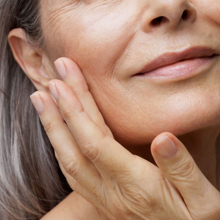 Closeup Of An Older Woman Taking Care Of Her Skin