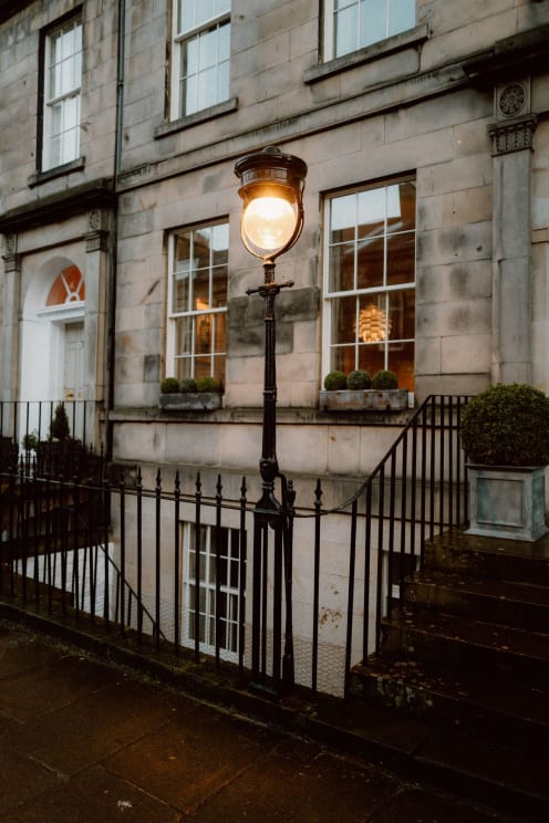 An Antique Street Lamp Outside Stone Row Houses