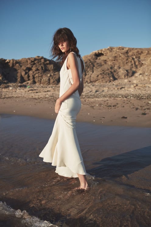 A Woman Walking Down A Beach