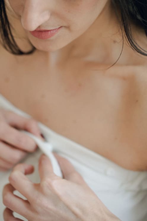 Woman Adjusts A Strap Of Her Clothing
