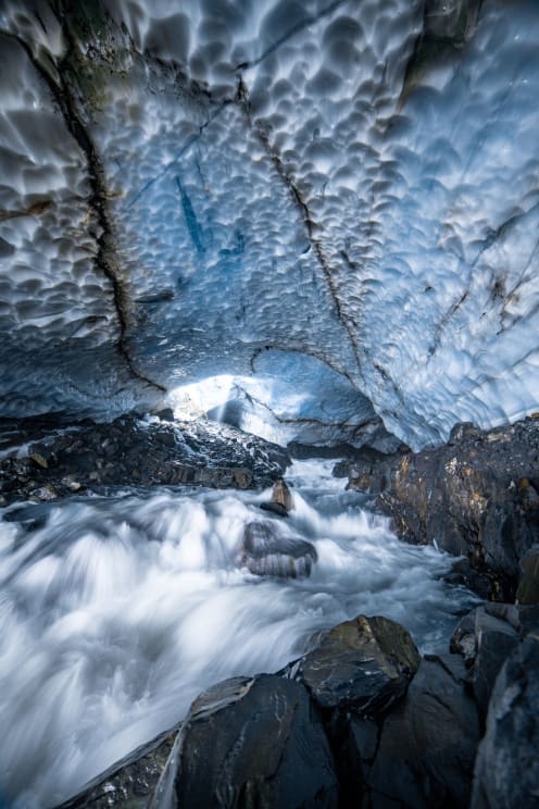 A River Moves Through A Rocky Icy Cave