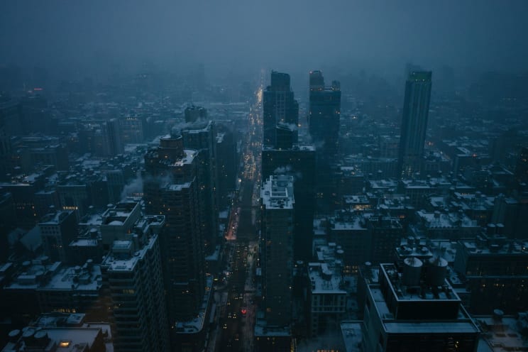 Lights Dot The Gloomy City At Dusk