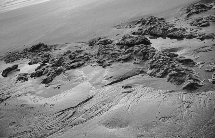 Footprints On A Sandy Beach