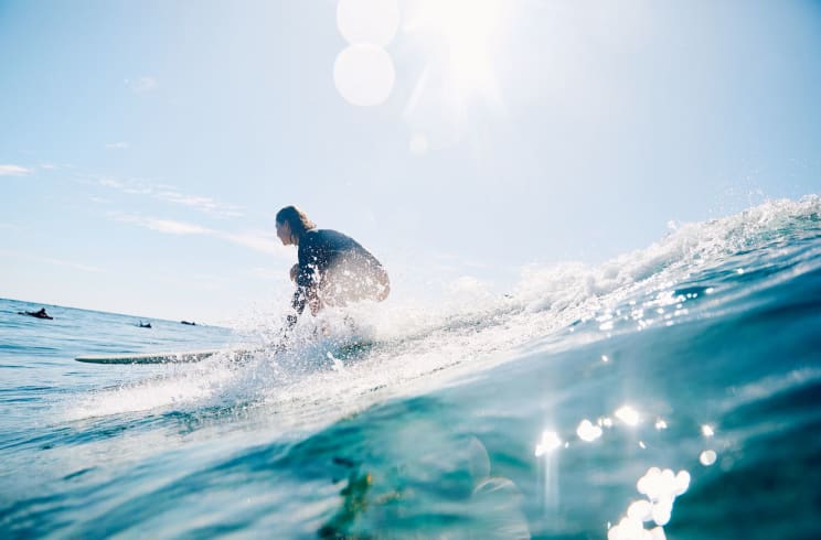 A Woman Surfing In The Ocean