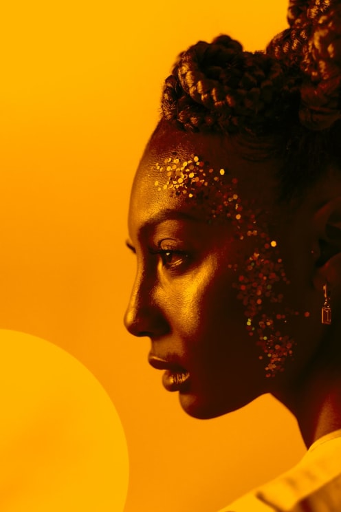 A Woman With Glitter On Her Face In Closeup
