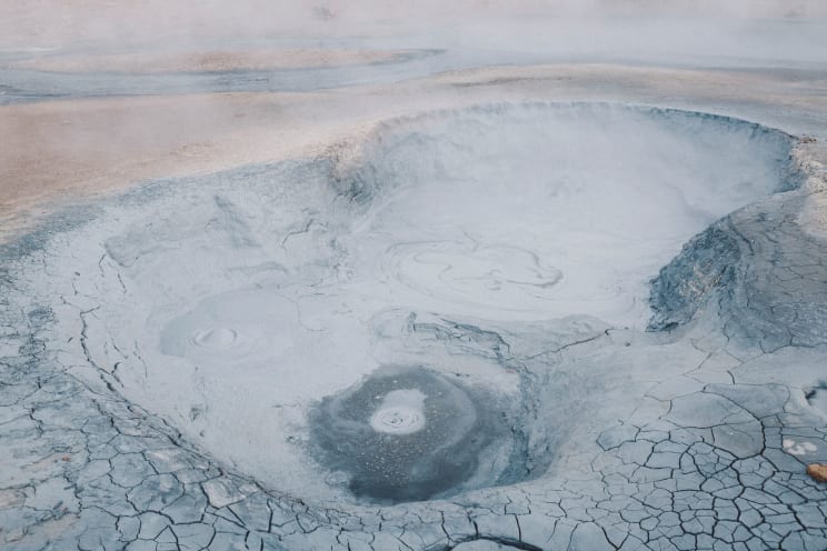 Steam Covers A Barren Landscape With Craters In Iceland