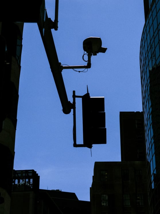 Silhouetted Traffic Lights Against A Blue Sky