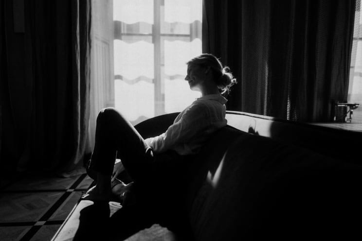 Woman Sitting On A Comfortable Sofa In Her Apartment