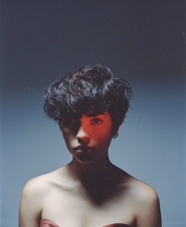 A Person With Black Hair And A Neutral Expression