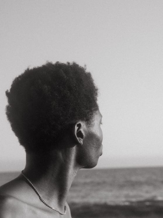 A Person Meditating On The Beach
