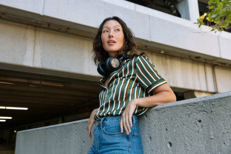 A Happy Woman In Los Angeles Wearing Jeans And Headphones Enjoying Herself