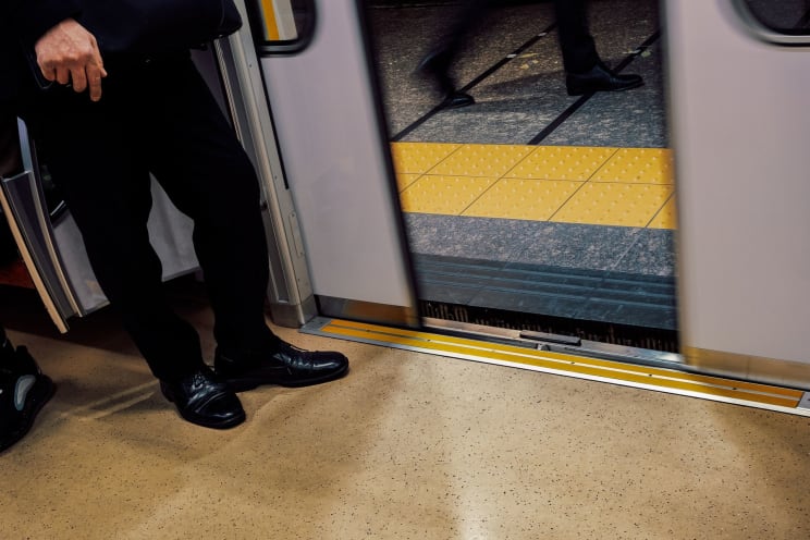A Subway Door Opening Revealing The Yellow Safety Line On The Outside