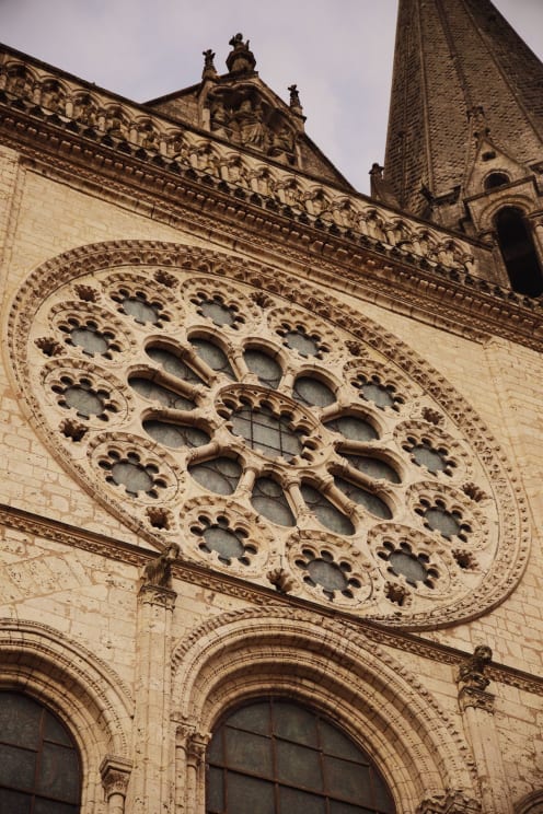 A Church Building With A Tower Located Outdoors During The Day