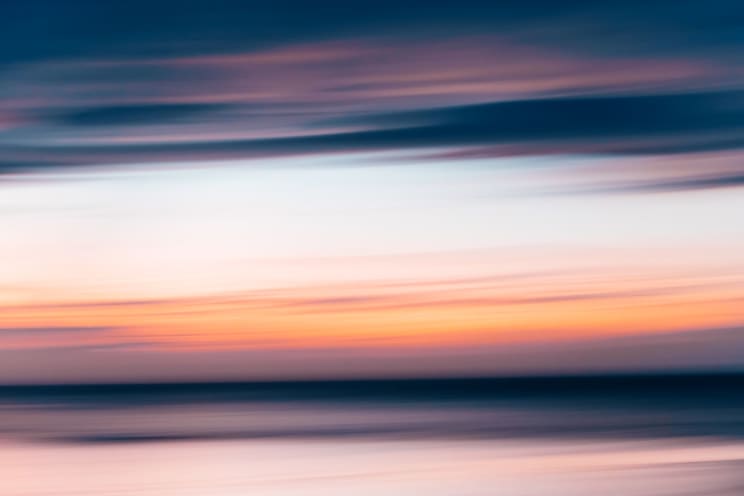 A Blurry Sunset Over A Natural Landscape At Dusk With Dark And Eerie Lighting