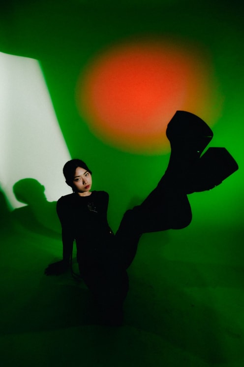 A Woman Sitting On The Ground With Her Leg In The Air