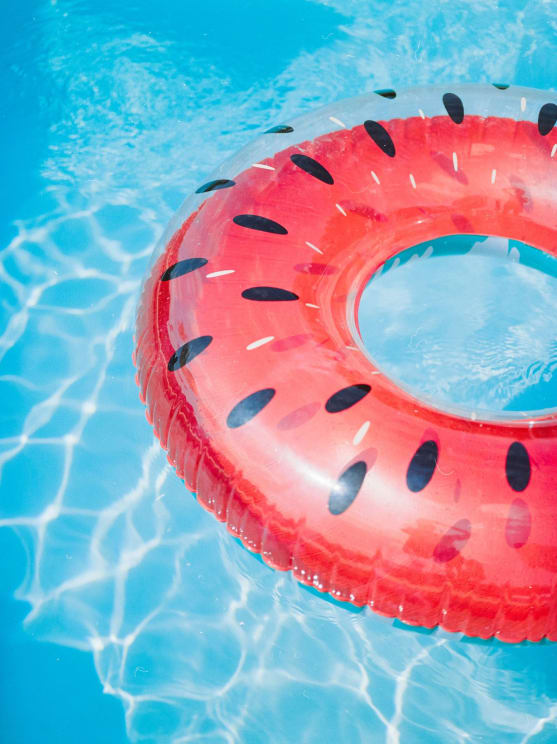 Watermeloncolored Plastic Float In A Swimming Pool