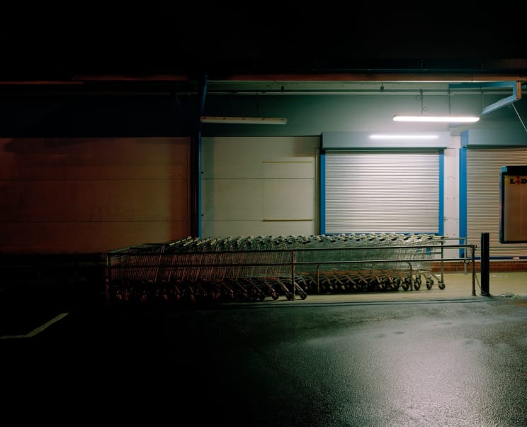 A Rainsoaked Street Illuminated By Street Lights