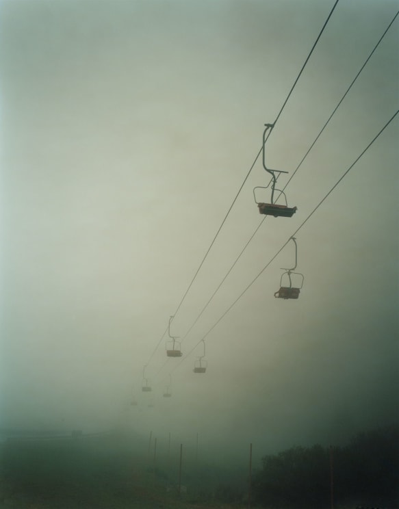 A Ski Lift Disappearing Into Foggy Mist
