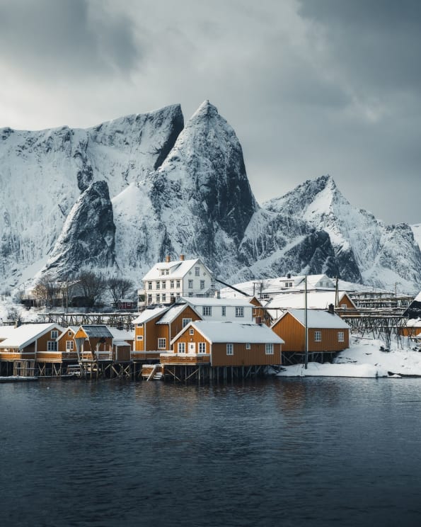 A Small Coastal Town Near Snowcovered Mountains