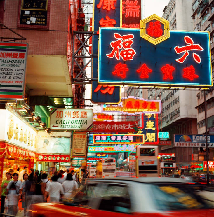 Colorful Signs Written In Chinese On A Busy Commercial Street In The City