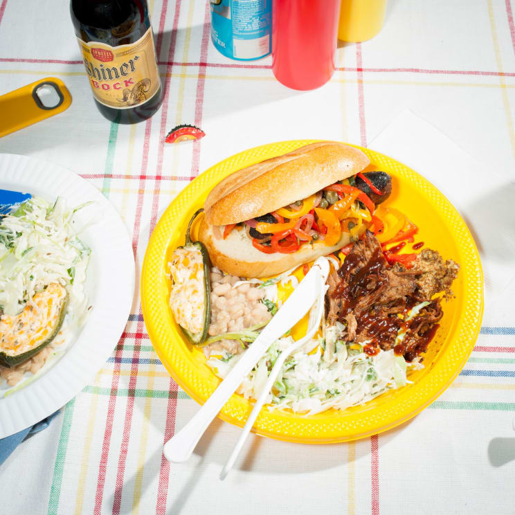 A Plate Of Food With Meat Beans Peppers And Sausage Surrounded By Beer And Other Food