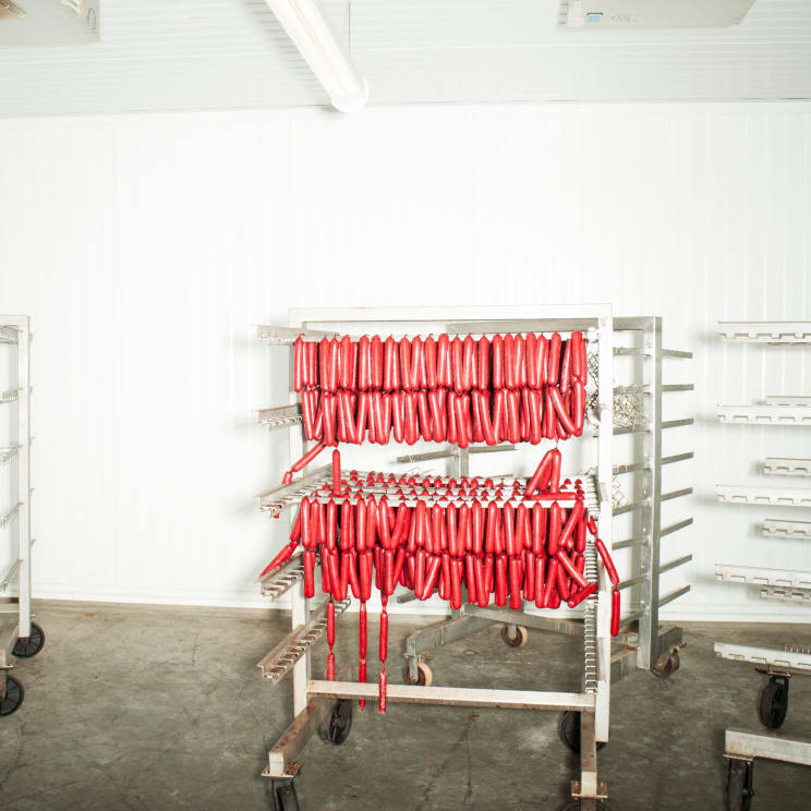 Deer Pepperoni Sticks Hanging On A Steel Rack In An Interior Location