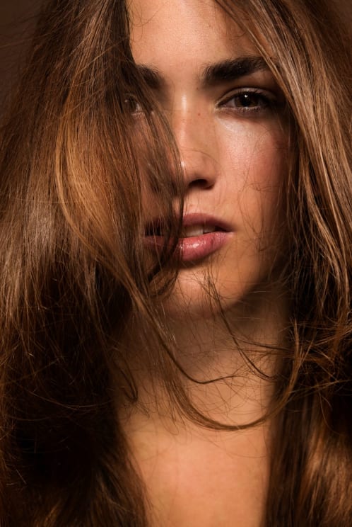 A Young Adult Woman With Layered Hair Neutral Expression And Flash Photography Lighting