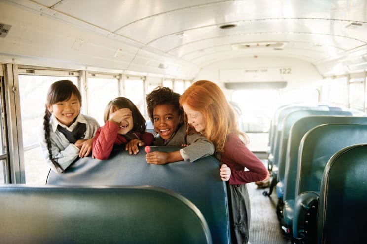 Four Girls Laugh On A School Bus