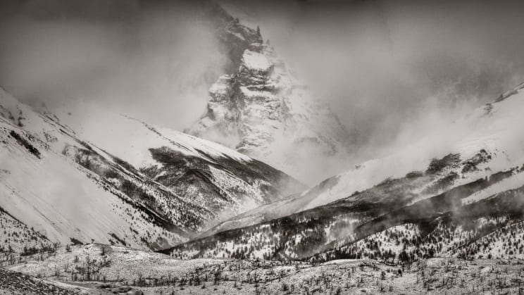 Snowy Mountain Slopes And Valley Landscape