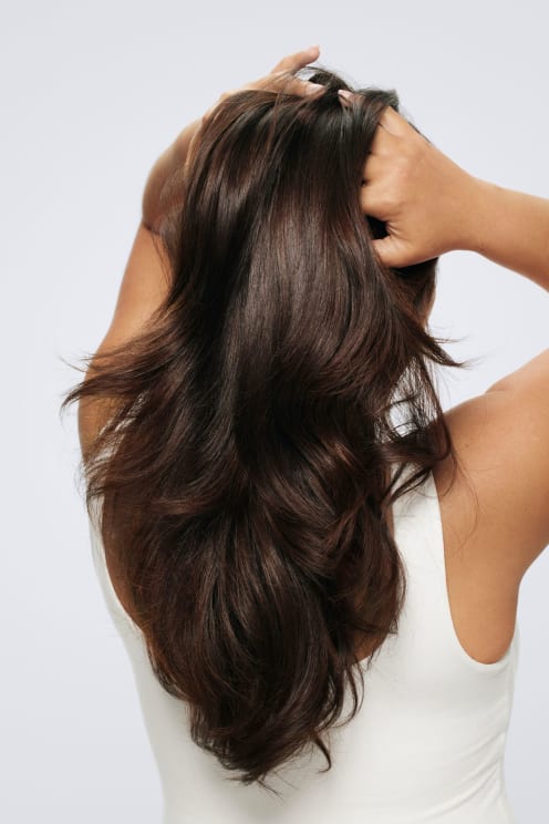 A Woman Runs Her Fingers Through Her Hair
