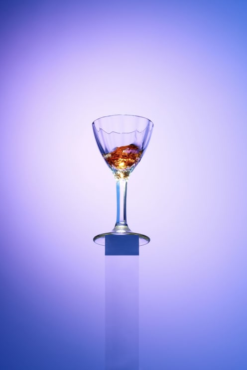 A Glass Filled With A Liquid Beverage