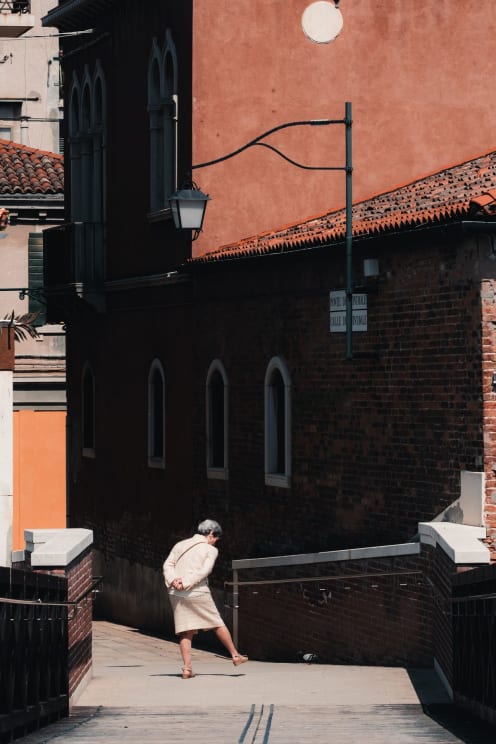 Old Lady Walking In The Urban Area