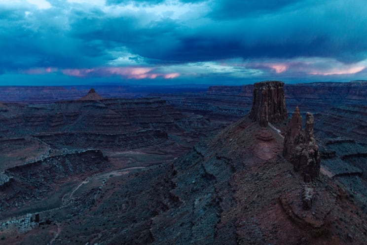 A Rocky Canyon Landscape With Storm Clouds At Dusk