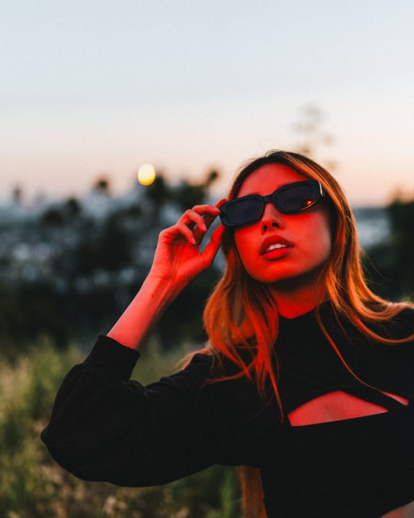 Woman In Sunglasses Outdoors In Red Lighting