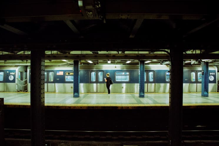 A Woman Waits At An Underground Subway Station