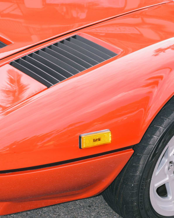 A Red Sports Car Shines In The Sunlight