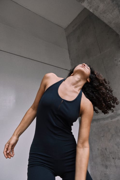 A Woman Poses Inside A Concrete Building