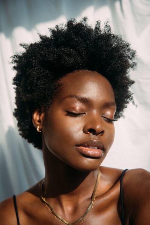 A Portrait Of A Black Woman Standing Outdoors On A Sunny Day