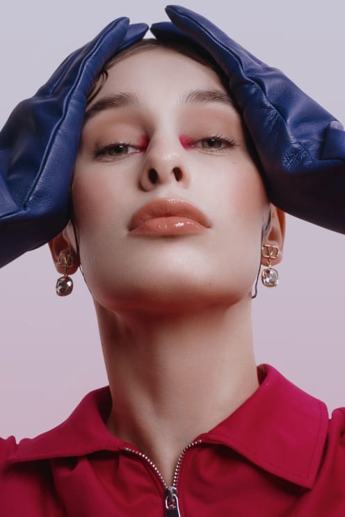 A Young Female Model With Make-up, Gloves And Earrings