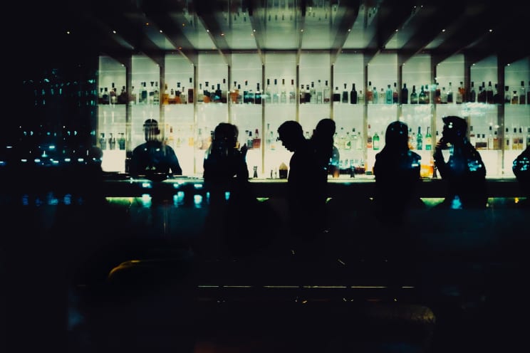 Men And Women Chat At A Restaurant Bar