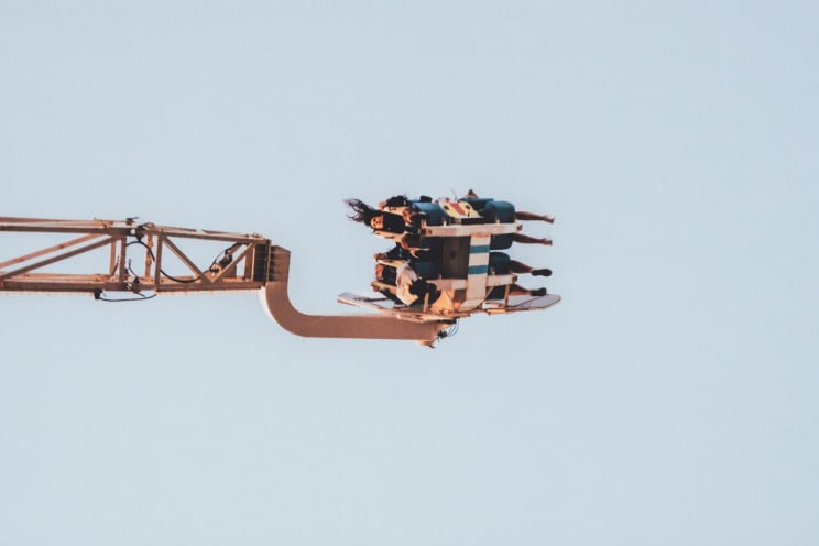 A Group Of People Riding A Thrill Ride At A Theme Park