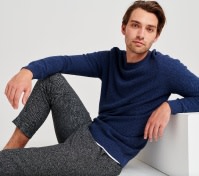Man in grey trousers and blue jumper