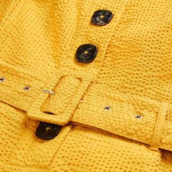 Close up of buttons on a dress and a belt