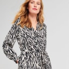 Female model wearing black monochrome zebra print dress