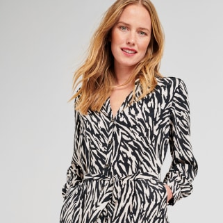 Stitch Fix model wearing a petite black and white monochrome zebra print shirt dress.