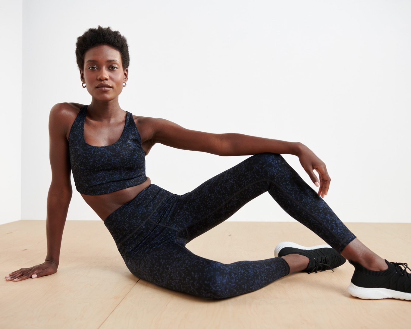 Model wearing Stitch Fix We Wander indigo performance leggings and matching sports bra.