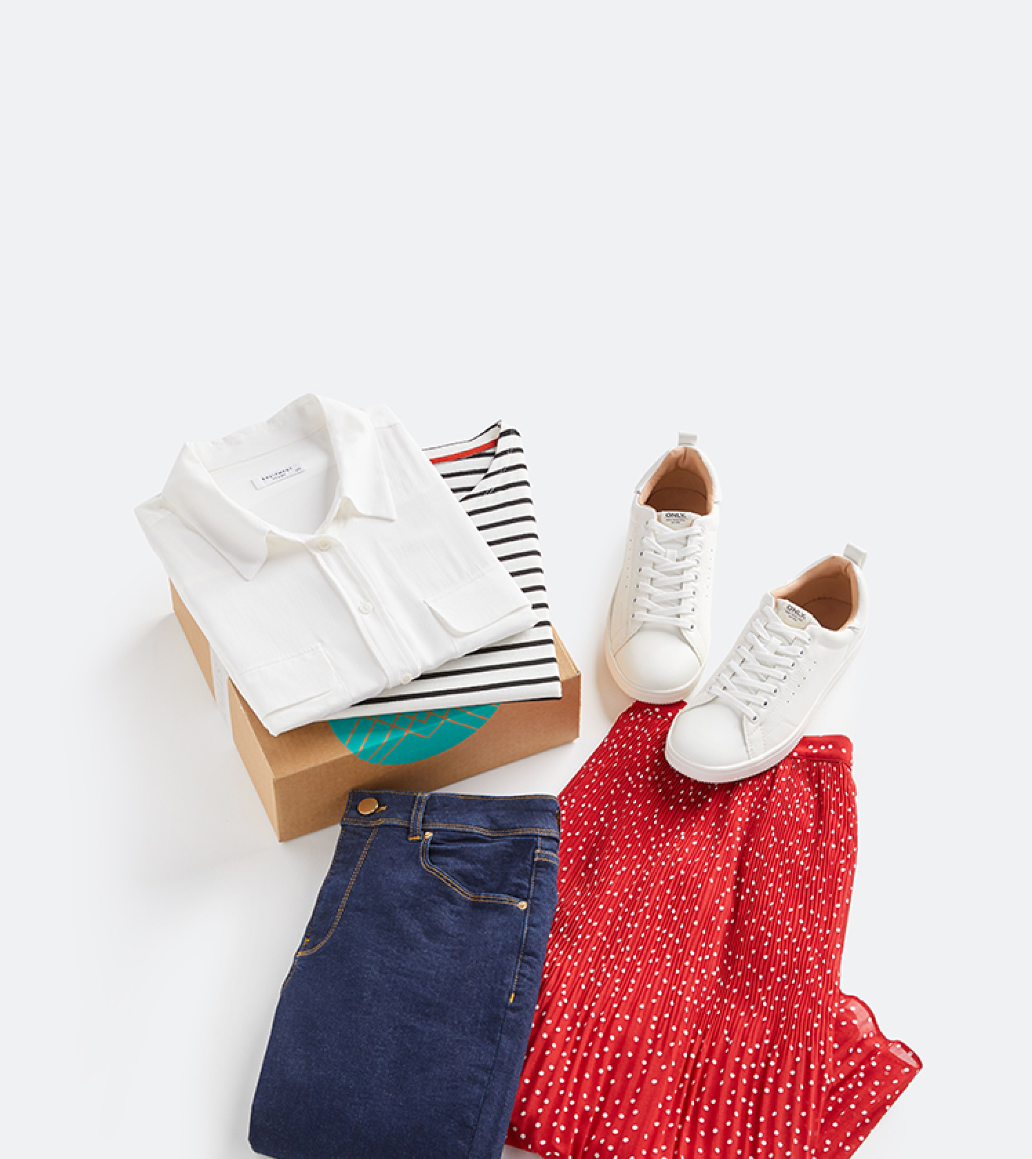 Stitch Fix box containing a selection of Stitch Fix women's clothes including a white shirt with breast pockets, a black and white Breton stripe top, white trainers, a red polka dot pleated midi skirt and dark blue jeans.