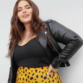 Black top with black leather jacket and leopard print skirt.